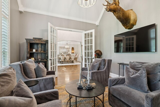 2433 Durham Manor Dr, Franklin, TN 37064 - living area featuring crown molding, french doors, wood finished floors, vaulted ceiling, and a chandelier