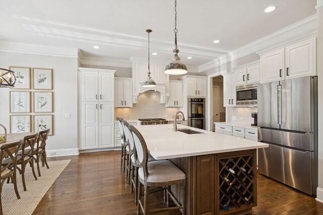 2433 Durham Manor Dr, Franklin, TN 37064 - kitchen with stainless steel appliances, baseboards, a sink, backsplash, and recessed lighting