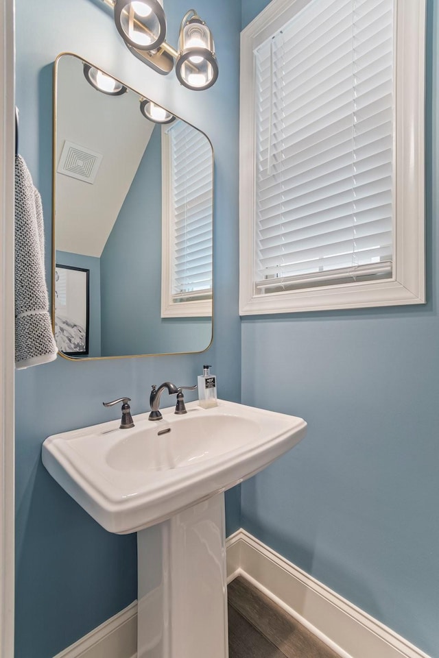 5540 Knob Rd, Nashville, TN 37209 - bathroom featuring a sink, baseboards, and a chandelier