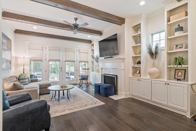 5540 Knob Rd, Nashville, TN 37209 - living room featuring dark wood-style floors, a ceiling fan, beamed ceiling, built in shelves, and a fireplace
