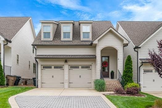 5540 Knob Rd, Nashville, TN 37209 - view of front of home featuring concrete driveway, an attached garage, a shingled roof, and a front lawn