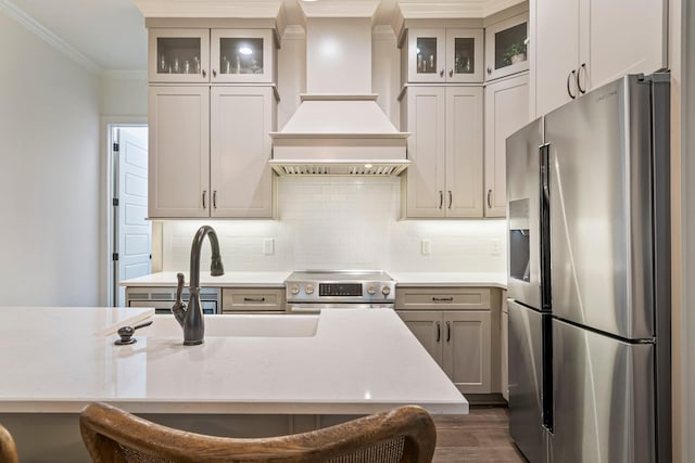 5540 Knob Rd, Nashville, TN 37209 - kitchen with appliances with stainless steel finishes, ornamental molding, light countertops, custom exhaust hood, and dark wood-style floors