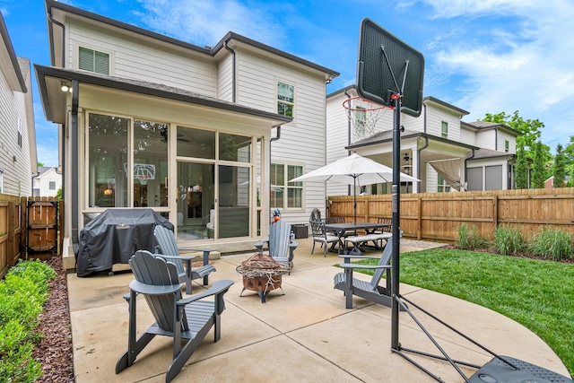 5540 Knob Rd, Nashville, TN 37209 - rear view of property featuring a fire pit, a sunroom, and a patio