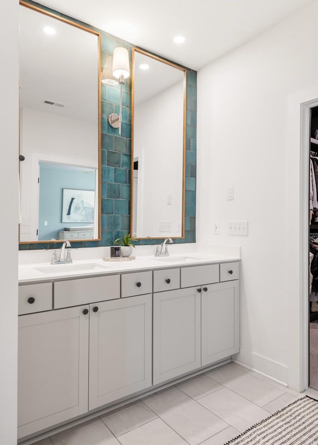 4042 Flowing Creek Dr, Franklin, TN 37064 - bathroom featuring double vanity, a walk in closet, tile patterned floors, recessed lighting, and baseboards