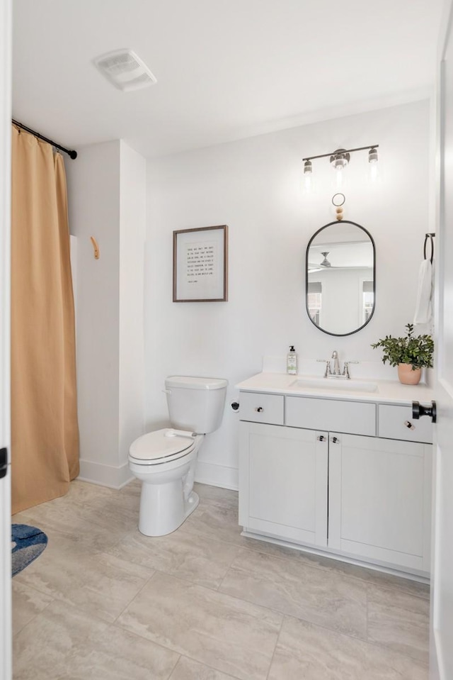 4042 Flowing Creek Dr, Franklin, TN 37064 - bathroom with vanity, toilet, baseboards, and a shower with shower curtain