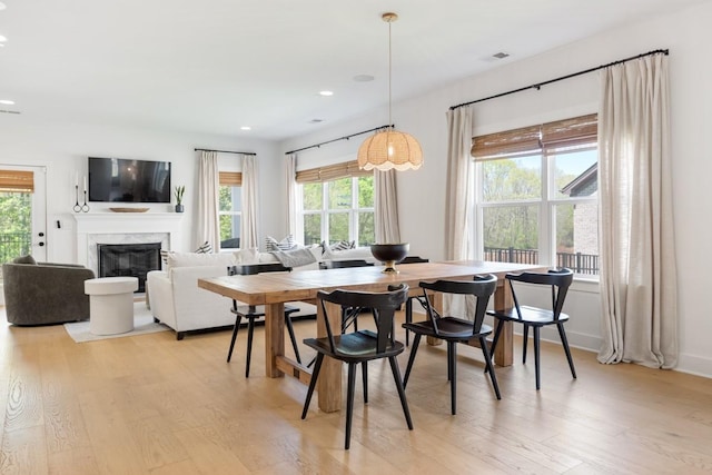4042 Flowing Creek Dr, Franklin, TN 37064 - dining area featuring light wood-type flooring, healthy amount of natural light, a premium fireplace, and recessed lighting