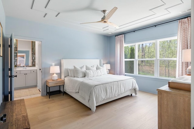 4042 Flowing Creek Dr, Franklin, TN 37064 - bedroom with light wood-style floors, ceiling fan, and connected bathroom