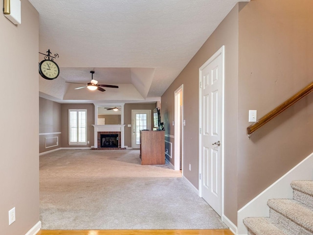 2999 Cages Bend Rd, Gallatin, TN 37066 - unfurnished living room with a tray ceiling, ceiling fan, stairs, carpet floors, and a textured ceiling