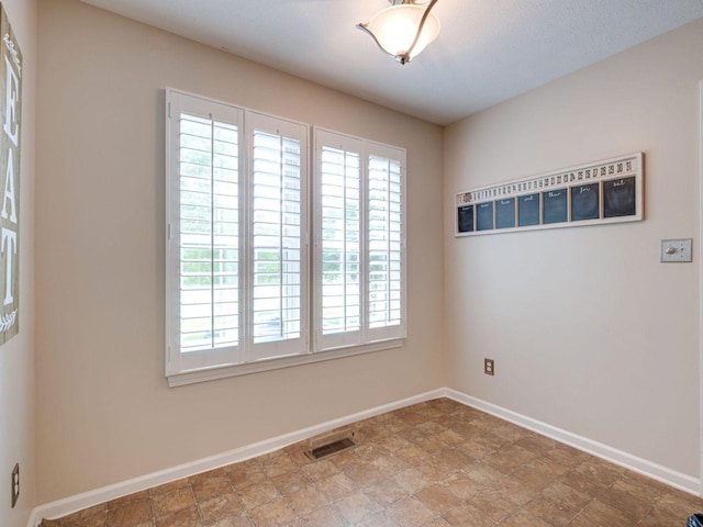 2999 Cages Bend Rd, Gallatin, TN 37066 - unfurnished room with healthy amount of natural light, baseboards, and stone finish floors