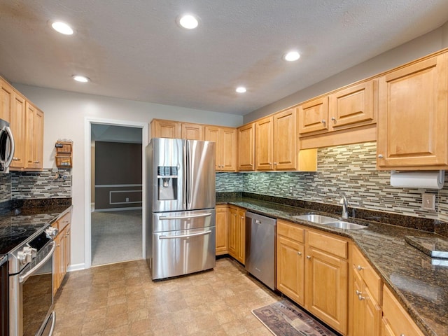 2999 Cages Bend Rd, Gallatin, TN 37066 - kitchen with stainless steel appliances, a sink, dark stone countertops, backsplash, and recessed lighting