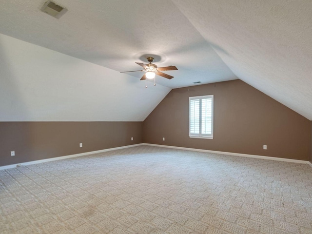 2999 Cages Bend Rd, Gallatin, TN 37066 - additional living space featuring carpet flooring, ceiling fan, a textured ceiling, vaulted ceiling, and baseboards