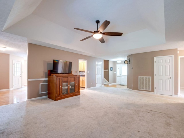 2999 Cages Bend Rd, Gallatin, TN 37066 - unfurnished living room featuring light carpet, baseboards, ceiling fan, and a tray ceiling