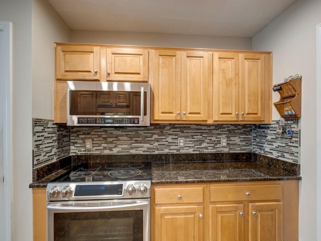 2999 Cages Bend Rd, Gallatin, TN 37066 - kitchen with appliances with stainless steel finishes, backsplash, and dark stone counters