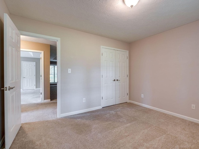 2999 Cages Bend Rd, Gallatin, TN 37066 - unfurnished bedroom featuring carpet floors, a textured ceiling, baseboards, and a closet