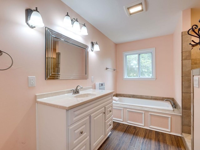 2999 Cages Bend Rd, Gallatin, TN 37066 - bathroom with vanity, a garden tub, and wood finished floors