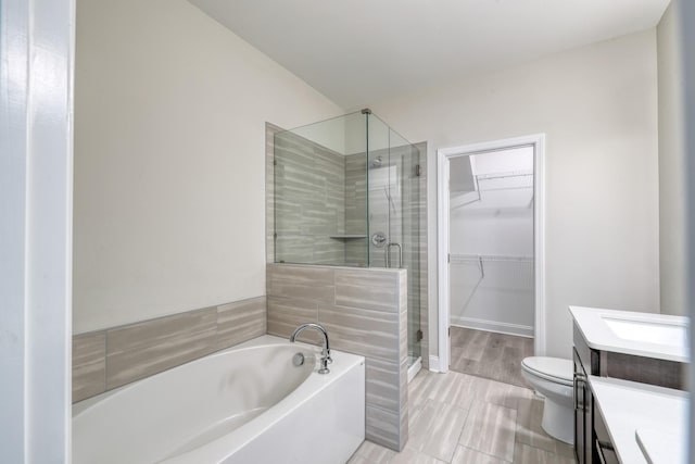3254 Tasker Dr, Antioch, TN 37013 - full bathroom featuring vanity, toilet, a garden tub, a shower stall, and a spacious closet