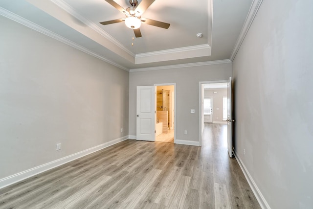 3254 Tasker Dr, Antioch, TN 37013 - spare room featuring light wood finished floors, a raised ceiling, ceiling fan, baseboards, and ornamental molding