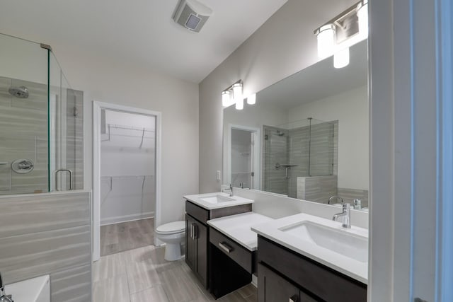 3254 Tasker Dr, Antioch, TN 37013 - bathroom with a stall shower, vanity, a spacious closet, and toilet