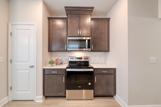 3254 Tasker Dr, Antioch, TN 37013 - kitchen with appliances with stainless steel finishes, tasteful backsplash, light countertops, and light wood-style floors