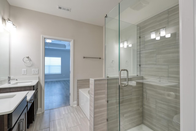 3254 Tasker Dr, Antioch, TN 37013 - bathroom with double vanity, a shower stall, a garden tub, and baseboards