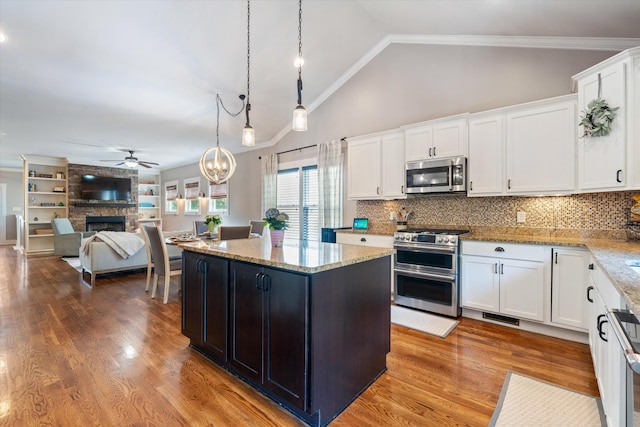 441 Highpoint Ter, Brentwood, TN 37027 - kitchen with appliances with stainless steel finishes, ceiling fan, white cabinets, a fireplace, and ornamental molding