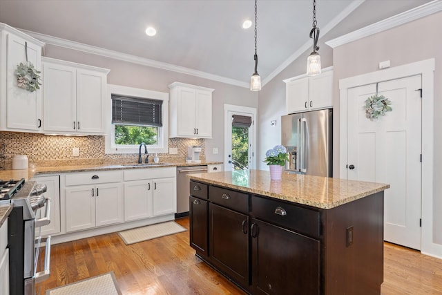 441 Highpoint Ter, Brentwood, TN 37027 - kitchen with stainless steel appliances, a sink, white cabinets, decorative backsplash, and pendant lighting