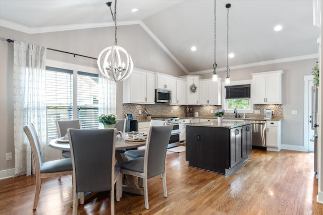441 Highpoint Ter, Brentwood, TN 37027 - kitchen with appliances with stainless steel finishes, a kitchen island, decorative backsplash, white cabinets, and vaulted ceiling