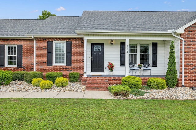 124 Mabry Dr, Murfreesboro, TN 37127 - view of front of home with covered porch, a front lawn, a shingled roof, and brick siding