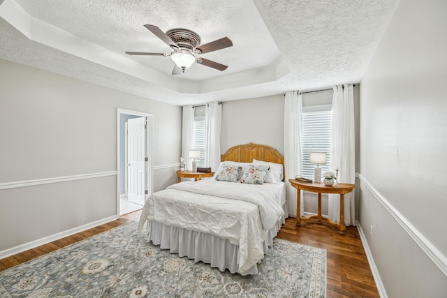 124 Mabry Dr, Murfreesboro, TN 37127 - bedroom featuring a textured ceiling, wood finished floors, a raised ceiling, baseboards, and a ceiling fan