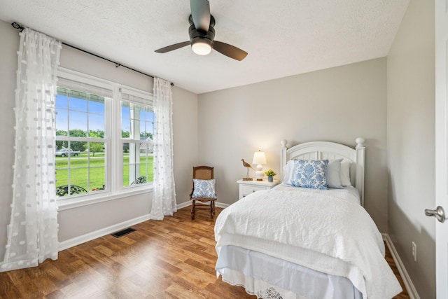 124 Mabry Dr, Murfreesboro, TN 37127 - bedroom with wood finished floors, baseboards, a textured ceiling, and a ceiling fan