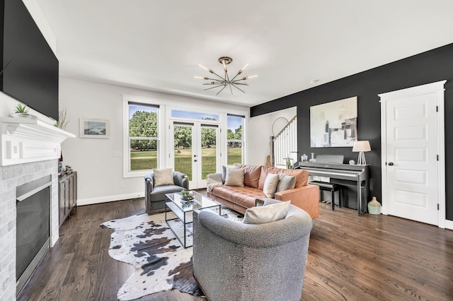 2734 Lakeland Dr, Nashville, TN 37214 - living room featuring a fireplace, a chandelier, wood finished floors, french doors, and baseboards