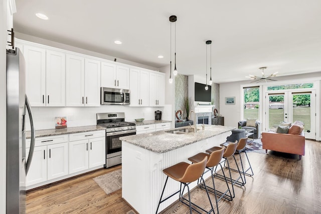 2734 Lakeland Dr, Nashville, TN 37214 - kitchen with stainless steel appliances, a sink, open floor plan, backsplash, and recessed lighting
