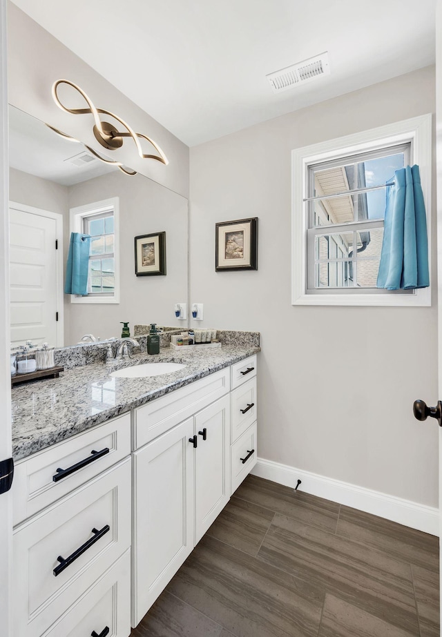 2734 Lakeland Dr, Nashville, TN 37214 - bathroom featuring vanity, baseboards, and wood finished floors