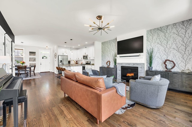 2734 Lakeland Dr, Nashville, TN 37214 - living area with a chandelier, dark wood finished floors, a glass covered fireplace, and recessed lighting