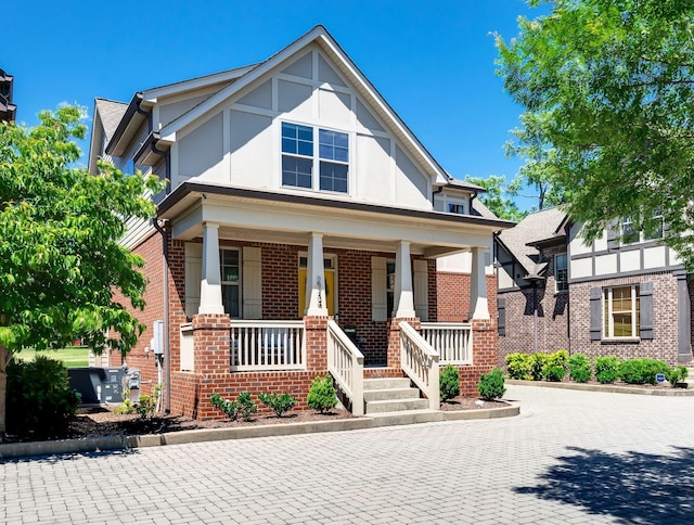 2734 Lakeland Dr, Nashville, TN 37214 - view of front of house with brick siding, a porch, and stucco siding