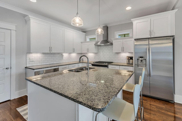 5407 Tennessee Ave, Nashville, TN 37209 - kitchen featuring appliances with stainless steel finishes, wall chimney exhaust hood, a sink, dark stone counters, and decorative backsplash