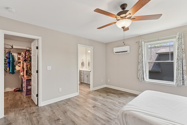 114 Eno Rd, Dickson, TN 37055 - bedroom with a wall mounted AC, a walk in closet, light wood-style flooring, and a closet