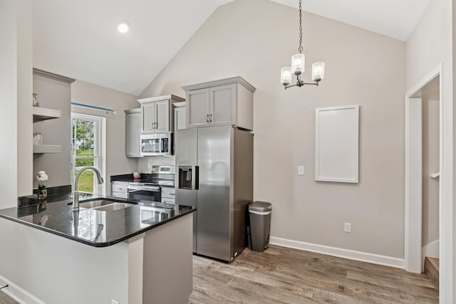 114 Eno Rd, Dickson, TN 37055 - kitchen featuring appliances with stainless steel finishes, open shelves, gray cabinetry, light wood-style flooring, and a peninsula
