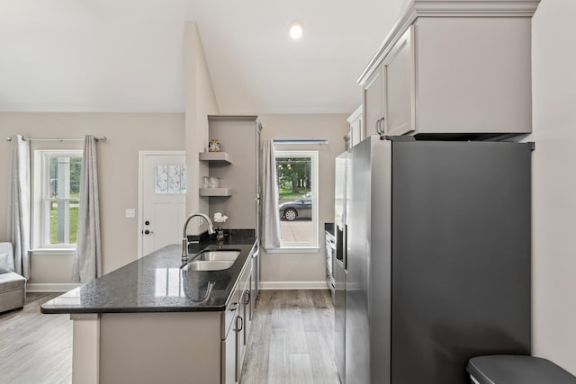 114 Eno Rd, Dickson, TN 37055 - kitchen with stainless steel refrigerator with ice dispenser, open shelves, light wood finished floors, a peninsula, and dark stone countertops