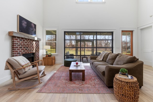 1222 Rock Church Rd, Dickson, TN 37055 - living area featuring a high ceiling, plenty of natural light, a fireplace, and wood finished floors