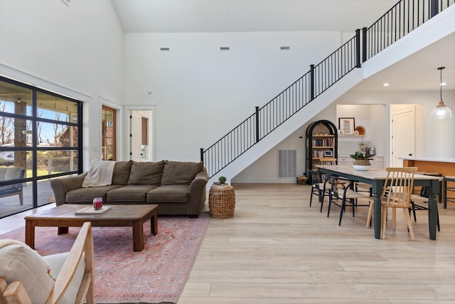 1222 Rock Church Rd, Dickson, TN 37055 - living room with a towering ceiling, light wood finished floors, stairway, and baseboards