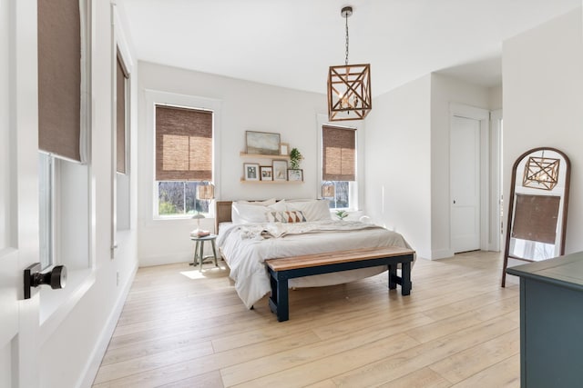 1222 Rock Church Rd, Dickson, TN 37055 - bedroom featuring light wood finished floors, baseboards, and a chandelier