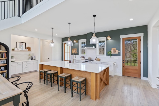 1222 Rock Church Rd, Dickson, TN 37055 - kitchen with open shelves, tasteful backsplash, white cabinets, light countertops, and light wood-style floors