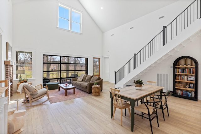 1222 Rock Church Rd, Dickson, TN 37055 - dining area featuring high vaulted ceiling, light wood-style flooring, and stairs