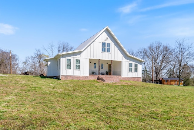 1222 Rock Church Rd, Dickson, TN 37055 - view of front of house featuring board and batten siding, a front yard, and covered porch