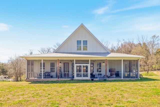 1222 Rock Church Rd, Dickson, TN 37055 - back of house featuring a sunroom, board and batten siding, a lawn, and metal roof