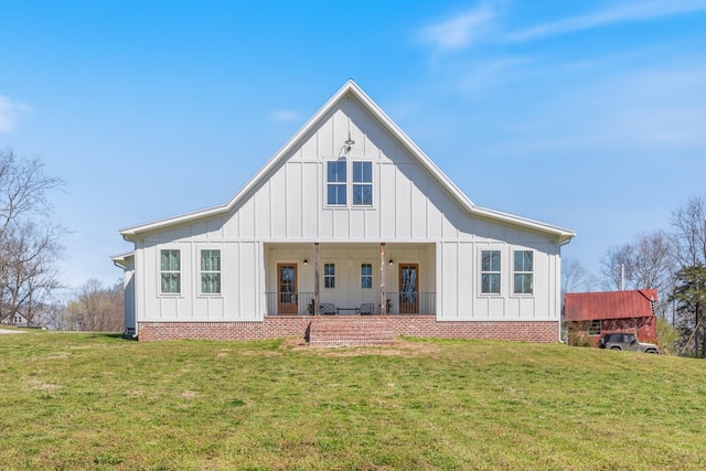 1222 Rock Church Rd, Dickson, TN 37055 - rear view of house with board and batten siding, a yard, and covered porch