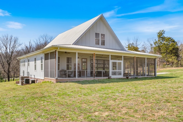 1222 Rock Church Rd, Dickson, TN 37055 - back of house featuring board and batten siding, a sunroom, ceiling fan, and a lawn