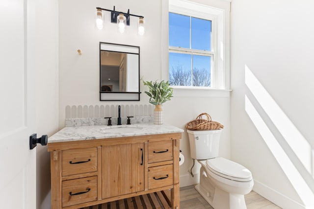 1222 Rock Church Rd, Dickson, TN 37055 - half bath with toilet, vanity, baseboards, and wood finished floors