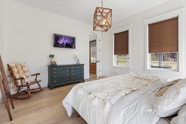 1222 Rock Church Rd, Dickson, TN 37055 - bedroom with light wood finished floors, a chandelier, and baseboards